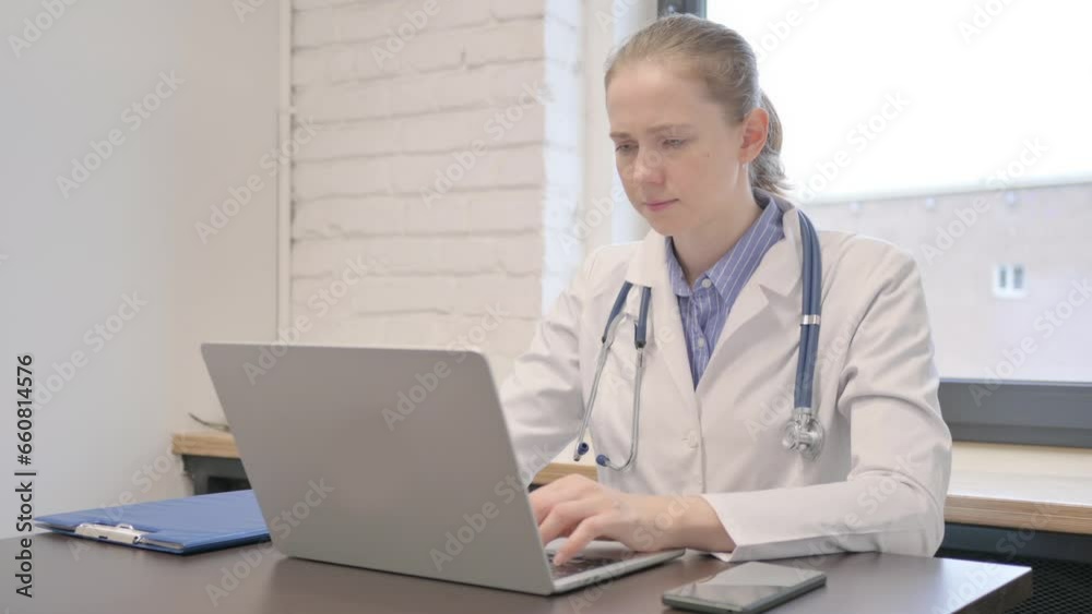 Female Doctor Working on Laptop while Sitting in Hospital Female Doctor Working on Laptop while Sitting in Hospital