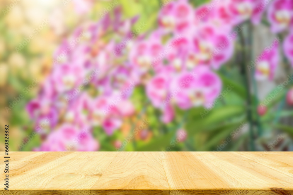 Empty wood table top with blur orchid garden background for product display Empty wood table top with blur orchid garden background for product display