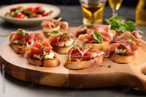 prosciutto bruschetta arranged on a circular wooden serving board