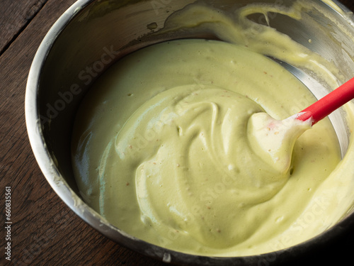 pandan chiffon cake batter in mixing bowl with spatula