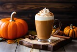 pumpkin spice latte with whipped cream on a wood slab