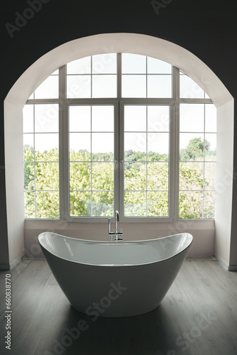Luxury modern white bathroom with light floor, panoramic window minimal design.
