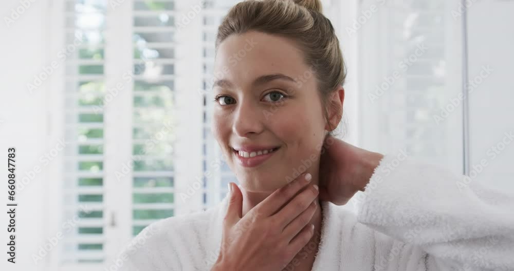 Happy biracial woman touching her face in bathroom, slow motion Happy biracial woman touching her face in bathroom, slow motion