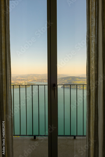 Window View with Balcony over Lake Lucerne and City of Lucerne with Mountain in Burgenstock, Nidwalden, Switzerland. © Mats Silvan