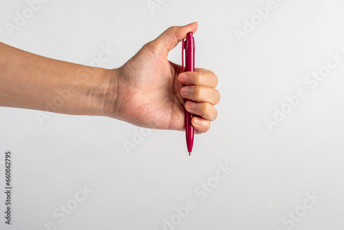 Hand holding pen isolated on white background photo