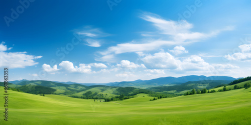 Landscape view of green grass on slope with blue sky and clouds background.. natural scenic panorama green field 