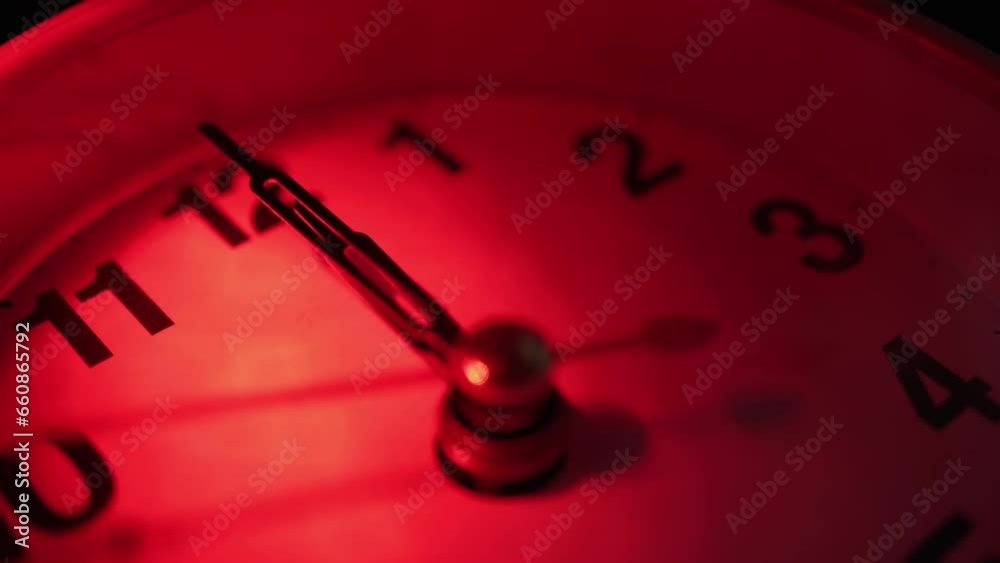 The clock shows the mystical time of 00:00. Midnight. Red light. It's 12 o'clock now, the dark forces are not asleep. Close-up.