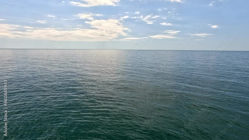 Sea water surface. Aerial view on calm water surface, camera flies over clear sea ocean. Sun glare. Abstract nautical summer ocean nature. Holiday and travel. Weather and climate change. Slow motion Sea water surface. Aerial view on calm water surface, camera flies over clear sea ocean. Sun glare. Abstract nautical summer ocean nature. Holiday and travel. Weather and climate change. Slow motion