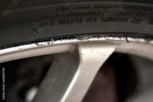 Curbed silver alloy wheel. Refined Alloy Wheels. Repairing Chipped Abrasions for Enhanced Aesthetics photo