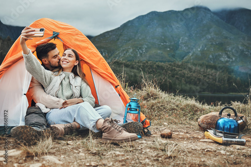 Couple, tent and kiss in camping selfie, memory and holiday on web blog, morning and countryside. Man, woman and relax with vacation, social network post and adventure with love, outdoor and freedom