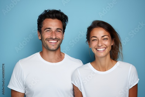 Portrait of a happy couple wearing blank white t-shirt isolated on a light blue background. Generative AI.
