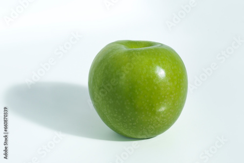 green whole apple granny on a black background with shadow top view photo