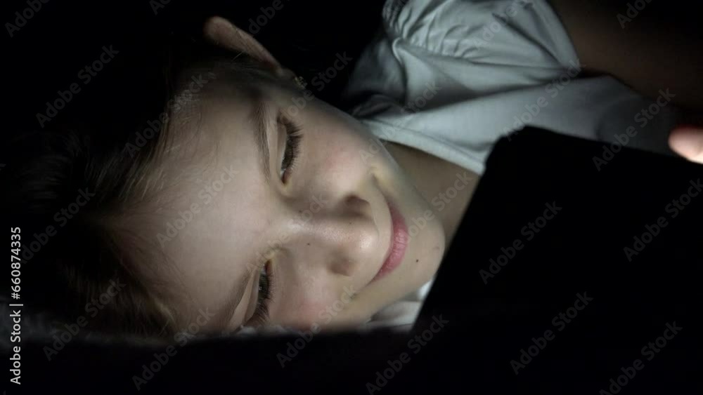 Child Playing Tablet in Night, Girl Browsing Internet in Bed, Kid Not Sleeping Searching Stuffs on Device, Children Play Games Child Playing Tablet in Night, Girl Browsing Internet in Bed, Kid Not Sleeping Searching Stuffs on Device, Children Play Games