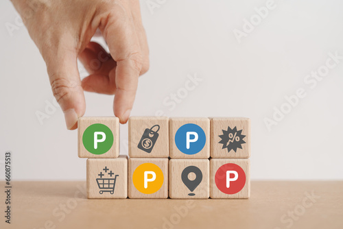 hand arranged 4Ps Marketing mix, Product Place Price Promotion, icon and text in multi color circle on wooden cube blocks with copy space