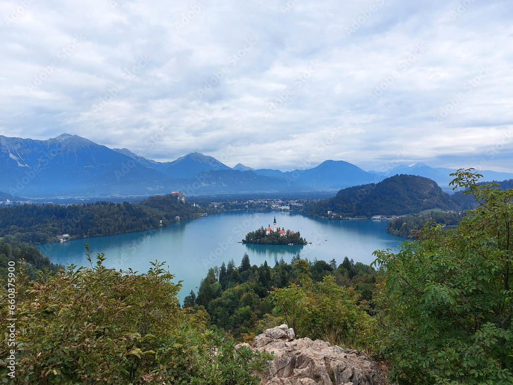 view to the island on lake Bled and dark blue mountains. Slovenia.
