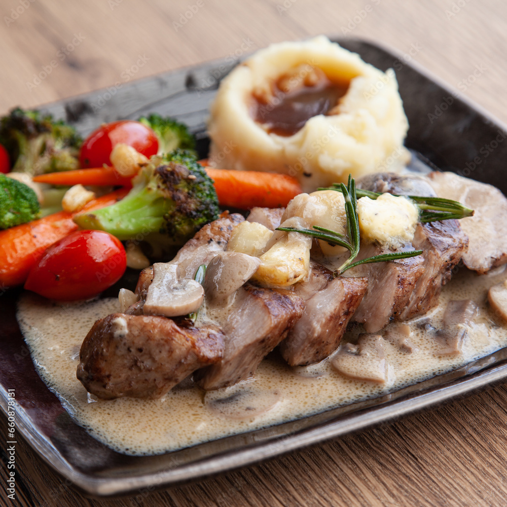 Pork shoulder steak with mushroom sauce, mashed potatoes and grilled vegetable Pork shoulder steak with mushroom sauce, mashed potatoes and grilled vegetable