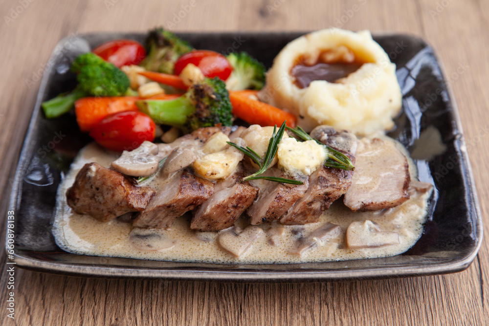 Pork shoulder steak with mushroom sauce, mashed potatoes and grilled vegetable Pork shoulder steak with mushroom sauce, mashed potatoes and grilled vegetable