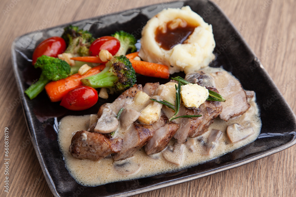 Pork shoulder steak with mushroom sauce, mashed potatoes and grilled vegetable Pork shoulder steak with mushroom sauce, mashed potatoes and grilled vegetable