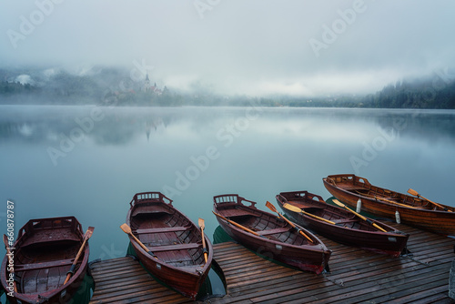 Famous alpine Bled lake (Blejsko jezero) in dense fog, amazing misty landscap...