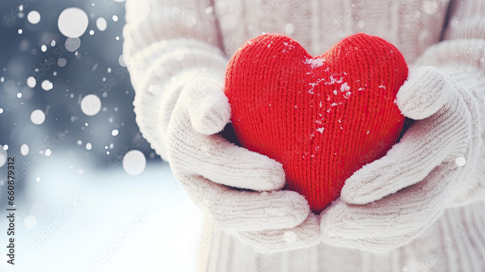 girl in gloves,  holding a knitted heart in her hands, winter theme