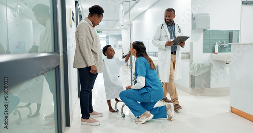 Black family, medicine and a pediatrician talking to a patient in the hospital for medical child care. Kids, trust or healthcare and a nurse consulting a boy with his mother in the clinic for health photo