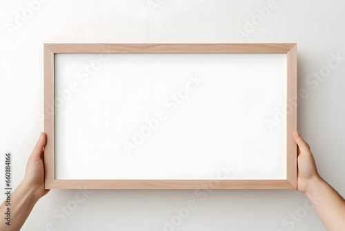 Close up hands holding blank horizontal decorative art transparent frame mock-up