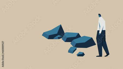 A businessman runs into an obstacle. There are several rocks in front of him.