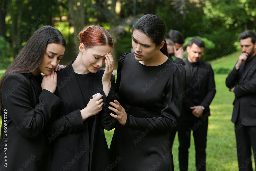 Sad people in black clothes mourning outdoors. Funeral ceremony Sad people in black clothes mourning outdoors. Funeral ceremony