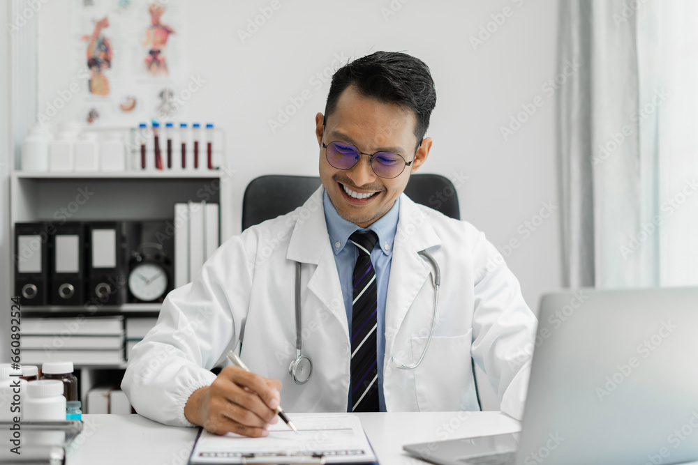 Doctor working on laptop computer and tablet and medical stethoscope on clipboard on desk, electronics medical record system EMRs concept. Doctor working on laptop computer and tablet and medical stethoscope on clipboard on desk, electronics medical record system EMRs concept.