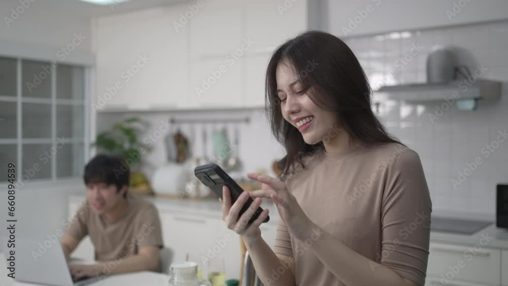 Young couple is shopping online in kitchen. Lifestyle and leisure activity concept. Young couple is shopping online in kitchen. Lifestyle and leisure activity concept.