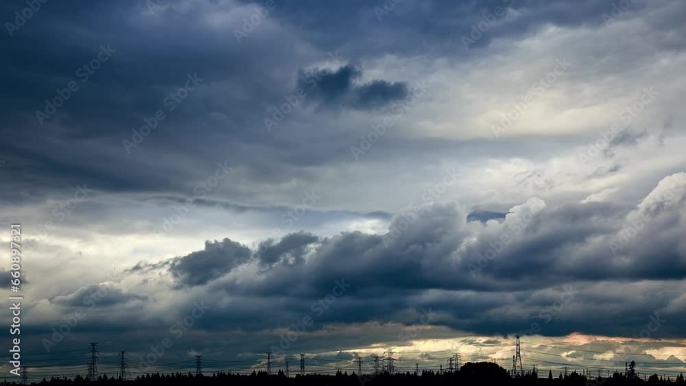 Landscape of fast moving dark clouds and high voltage power tower Landscape of fast moving dark clouds and high voltage power tower