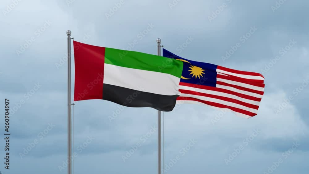 Malaysia and United Arab Emirates UAE flag waving together on cloudy sky, endless seamless loop, two country cooperation concept Malaysia and United Arab Emirates UAE flag waving together on cloudy sky, endless seamless loop, two country cooperation concept