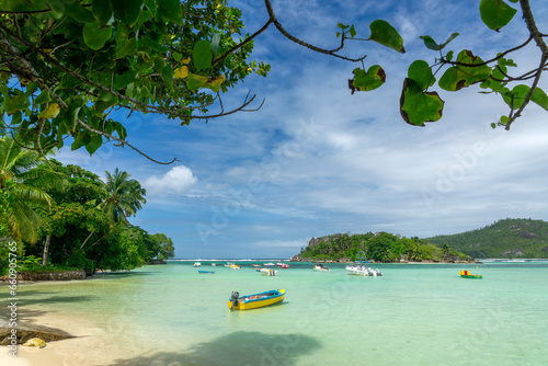 Colorful boats and transparent water in the lagoon of Anse l'Islette, Mahé island, Seychelles