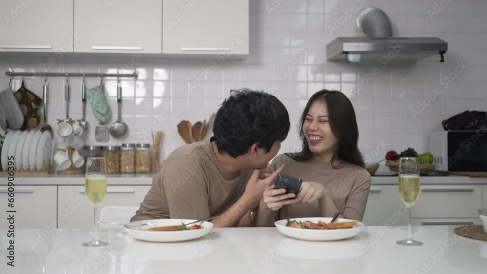 Young couple is shopping online in kitchen. Lifestyle and leisure activity concept. Young couple is shopping online in kitchen. Lifestyle and leisure activity concept.