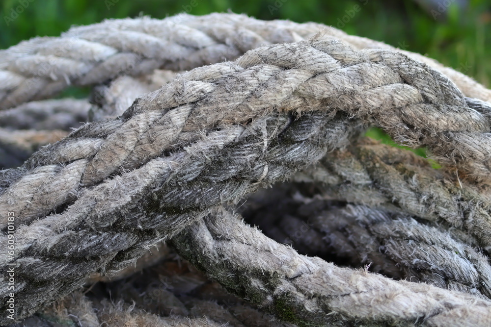 Old gray ship rope and the green background