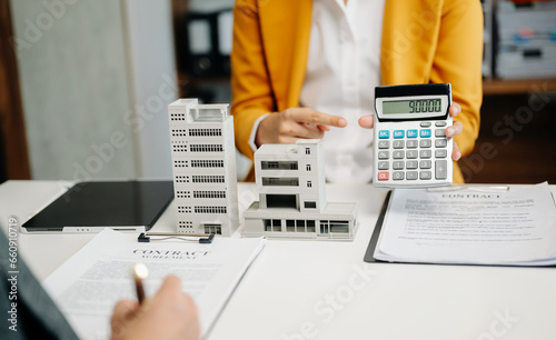 Customers who choose to buy a condominium room and a bank approve a loan for their purchase. Condominium and house loan interest rate from bank concept in office.