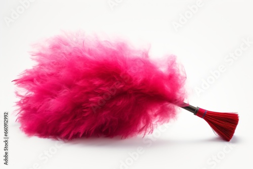 A pink feather duster isolated on a white background photo