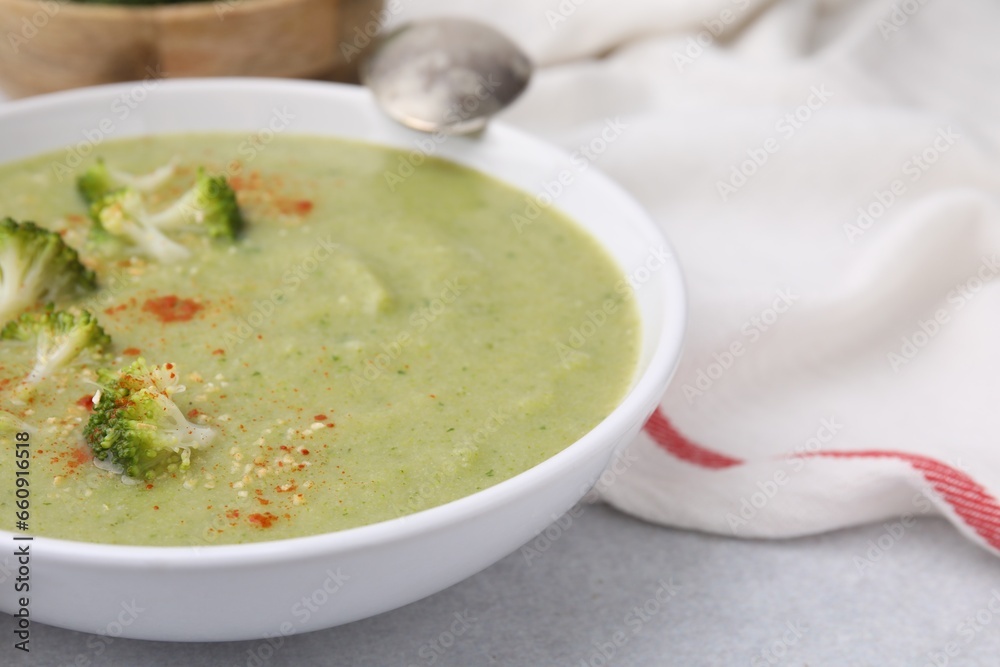 Delicious broccoli cream soup served on light table, closeup. Space for text Delicious broccoli cream soup served on light table, closeup. Space for text