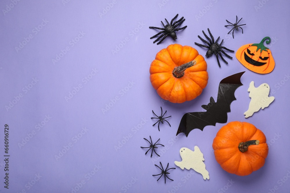 Flat lay composition with bat, pumpkins, ghosts and spiders on purple background, space for text. Halloween celebration