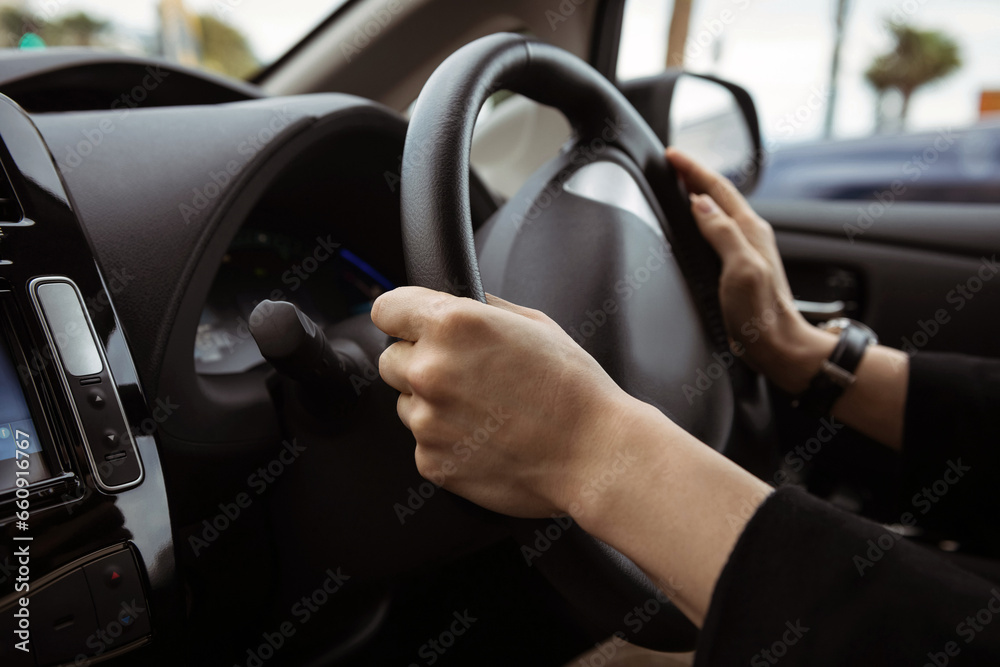 Driving a car photo background. Steering wheel and hands of a driver, city car interior Driving a car photo background. Steering wheel and hands of a driver, city car interior