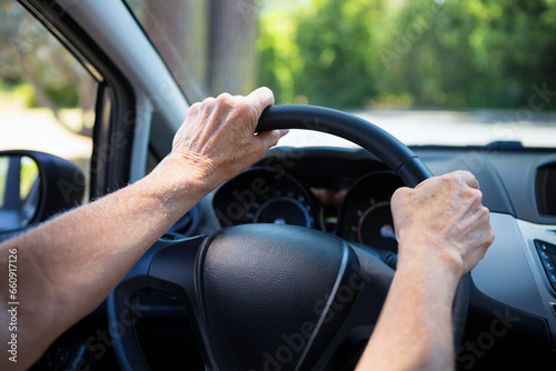 Car driving background. Steering wheel with driver's hands © Studio-M