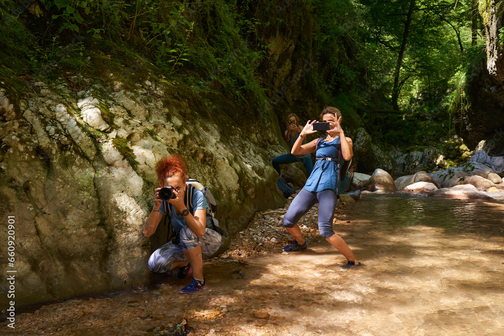 Hikers taking photos in a gorge