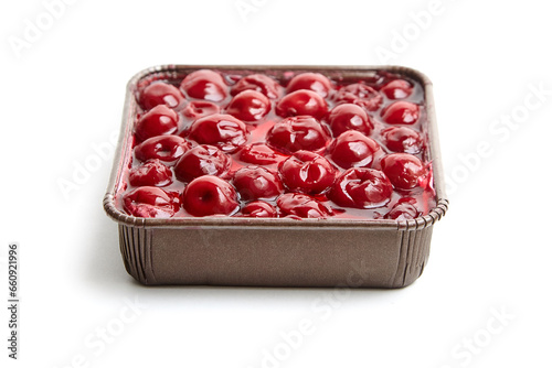 Mini viennese cherry pie in tray isolated on white. Biscuit cake with cherries under jelly