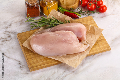 Raw chicken breast served rosemary