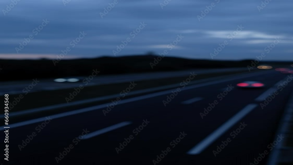vertical defocused and blurred video of cars driving along a highway at night, blue hour vertical defocused and blurred video of cars driving along a highway at night, blue hour