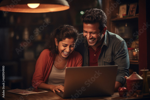 indian couple using laptop at home.