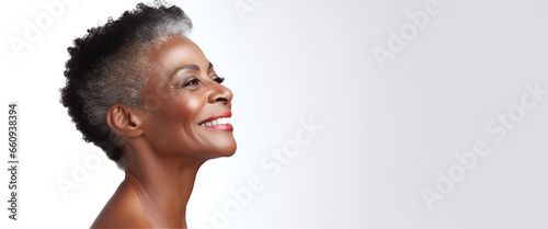 African american adult woman with smooth healthy face skin. Beautiful aging mature woman with curle gray hair and happy smiling. Beauty and cosmetics skincare advertising concept. photo