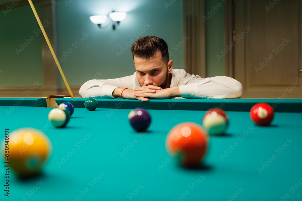 Fototapeta premium Billiard player calculate trajectory pathway at billard table or snooker american billiards pool sport game