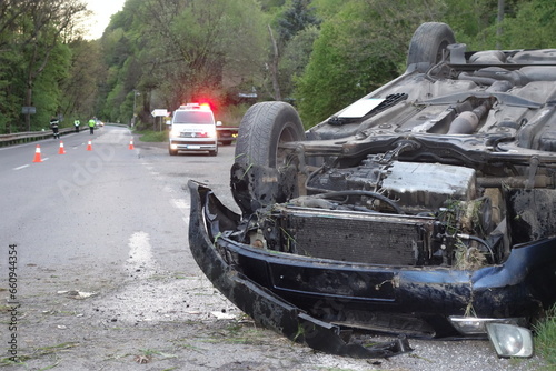 Car accident. An overturned car lying upside down on the street after an accident. The car crashed on the road and overturned. Real event. 