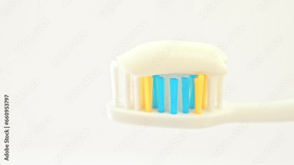 White toothpaste on a toothbrush close-up. White toothpaste on a toothbrush close-up.